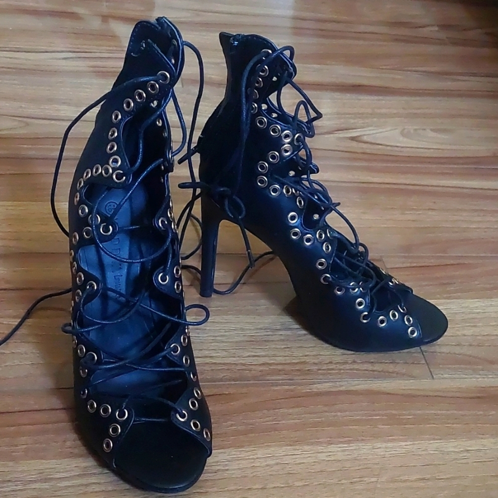 Black leather high heels with straps and zipper in the back. NEW,  NO BOX